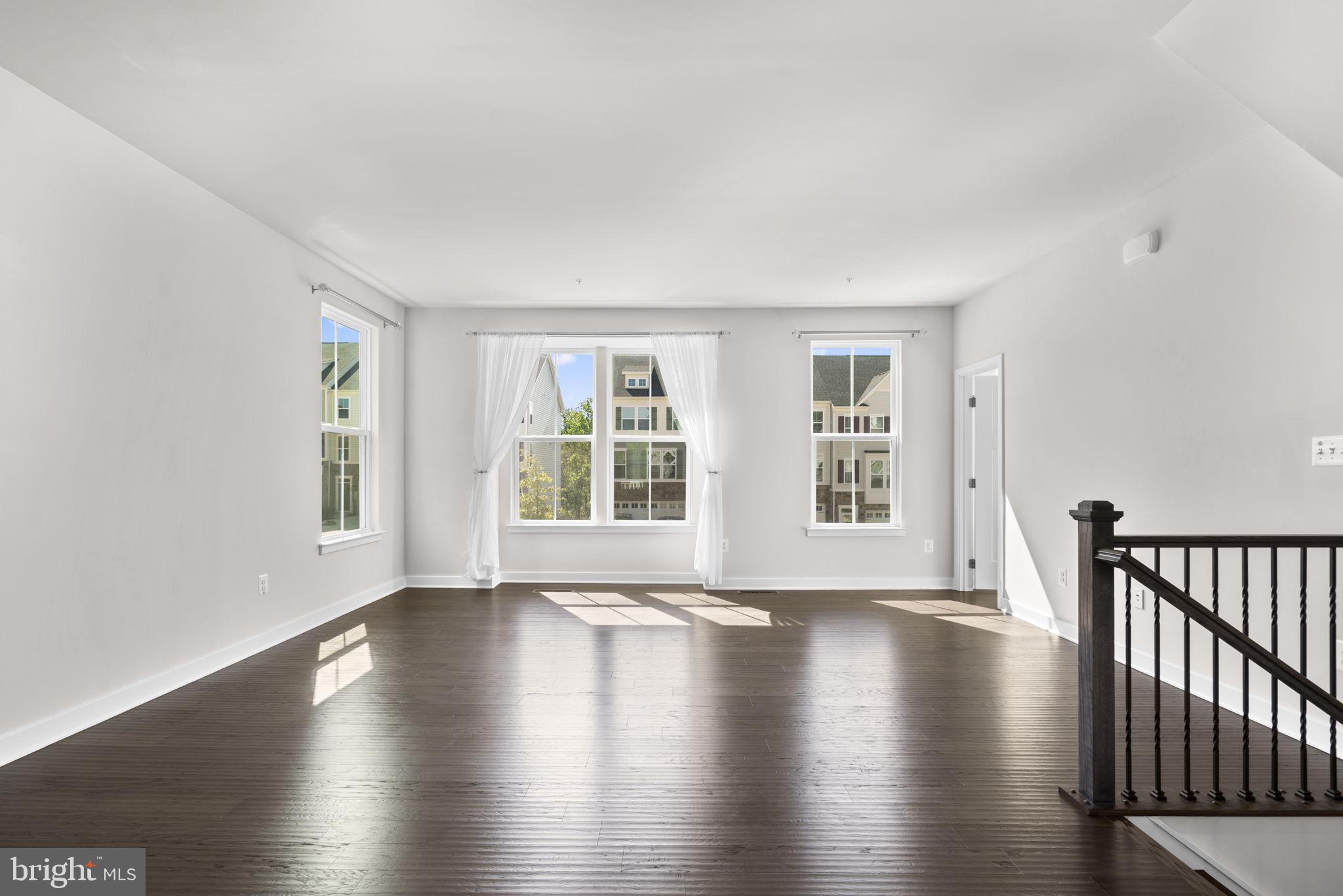 733 Iron Gate Road Bel Air, MD 21014 - Photo 3 of 41 a view of an empty room with wooden floor and a window