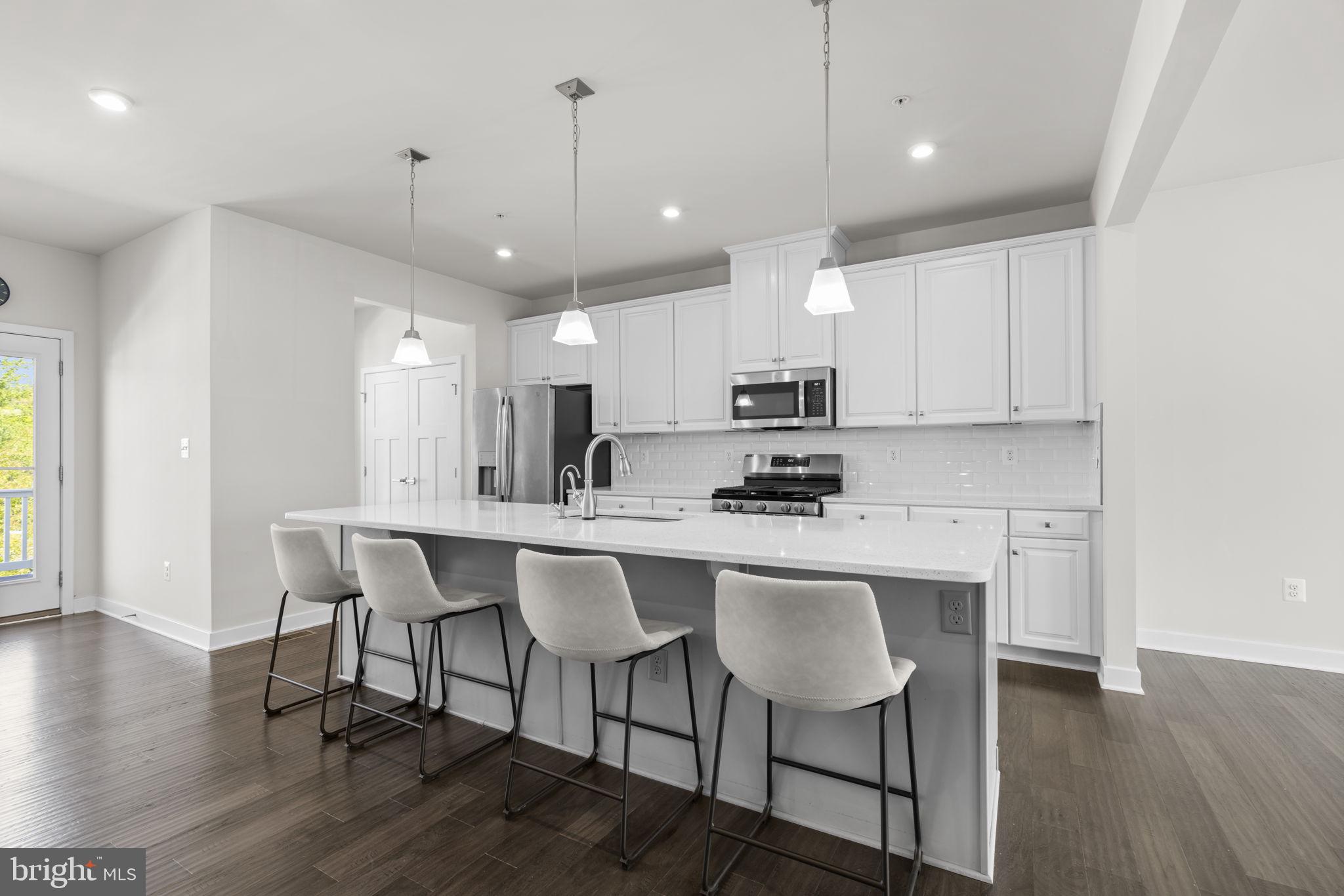 733 Iron Gate Road Bel Air, MD 21014 - Photo 6 of 41 a kitchen with stainless steel appliances kitchen island granite countertop a dining table chairs and sink
