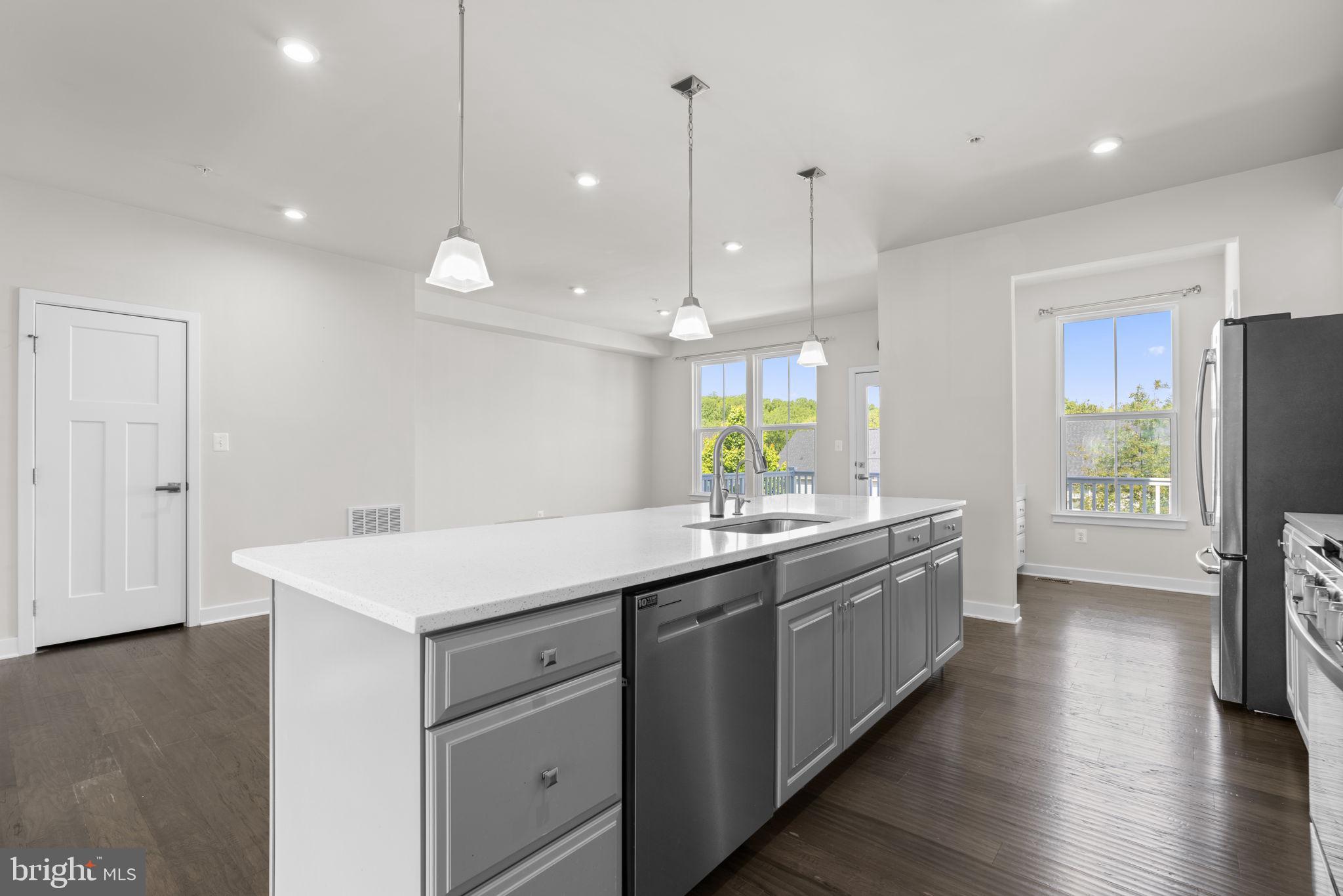 733 Iron Gate Road Bel Air, MD 21014 - Photo 10 of 41 a kitchen with a sink a counter top space stainless steel appliances and wooden floor