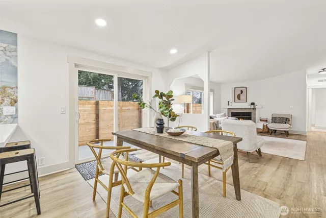 a living room with granite countertop furniture and a dining table with kitchen view