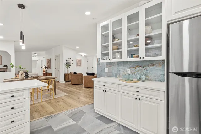 a kitchen with a white cabinets and sink