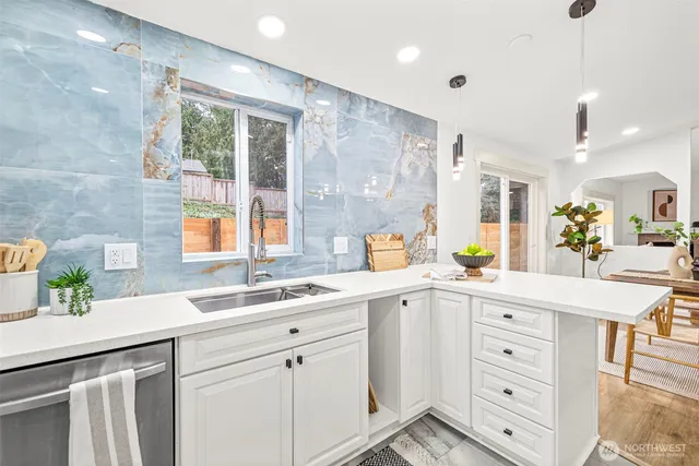 a kitchen with stainless steel appliances a sink stove and cabinets