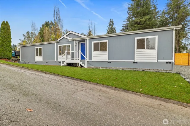 a front view of house with yard and green space