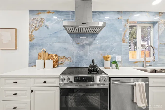 a kitchen with stainless steel appliances a refrigerator sink and cabinets