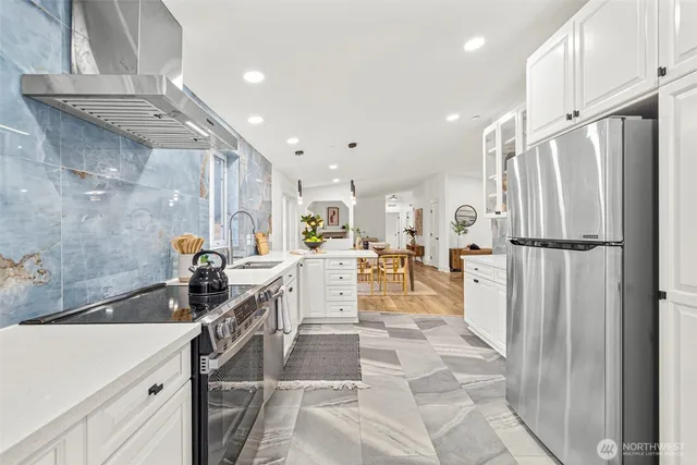 a view of a dining room with furniture and chandelier