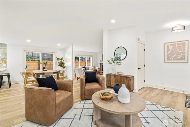 a living room with furniture a rug and a table