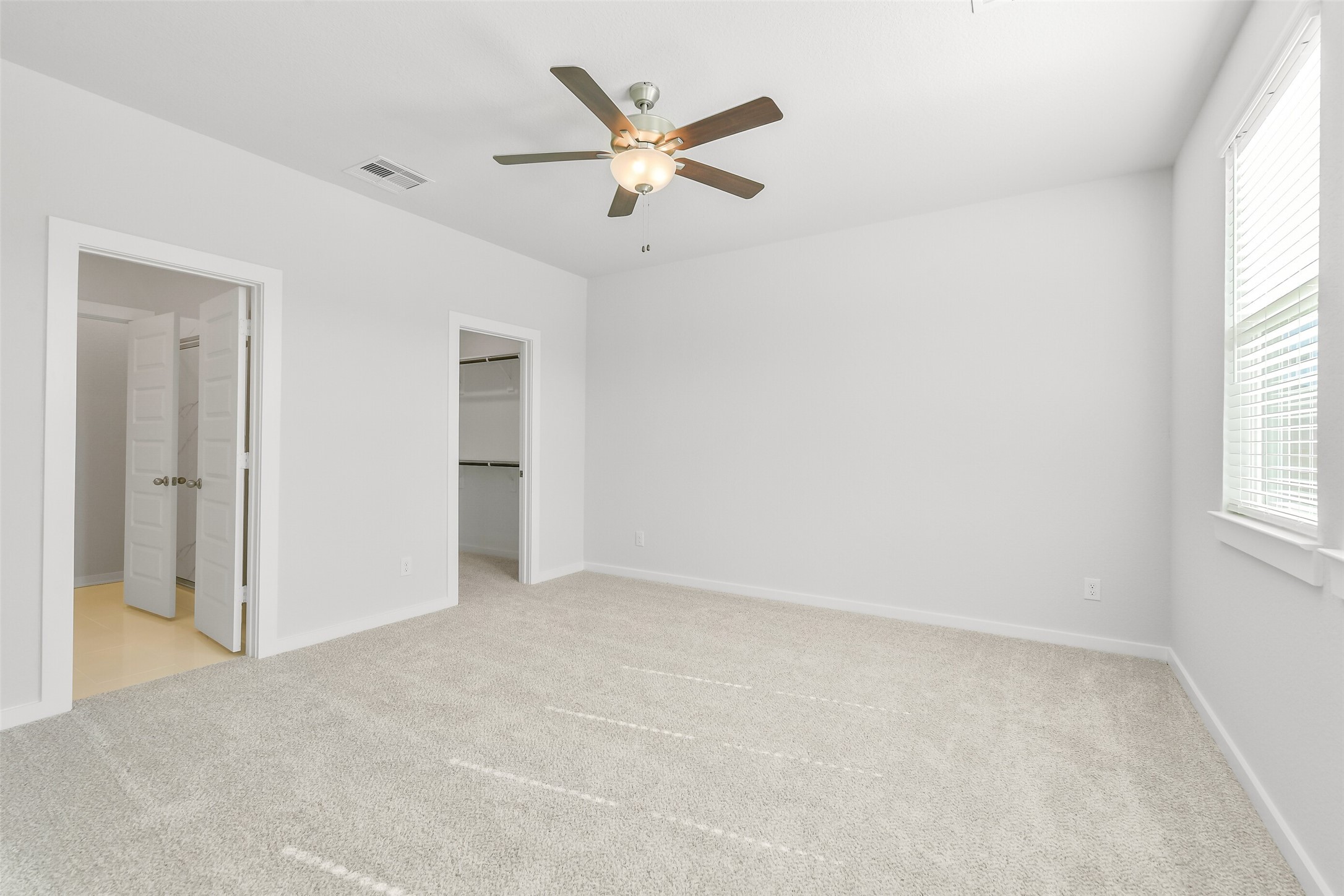 25980 Liberation Road Cleveland, TX 77328 - Photo 16 of 42 an empty room with a ceiling fan and window