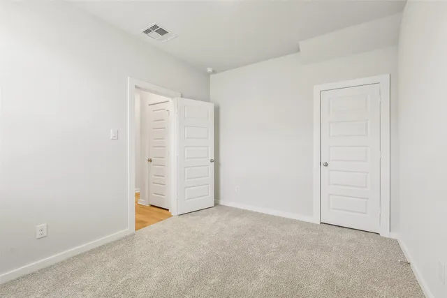 an empty room with closet area