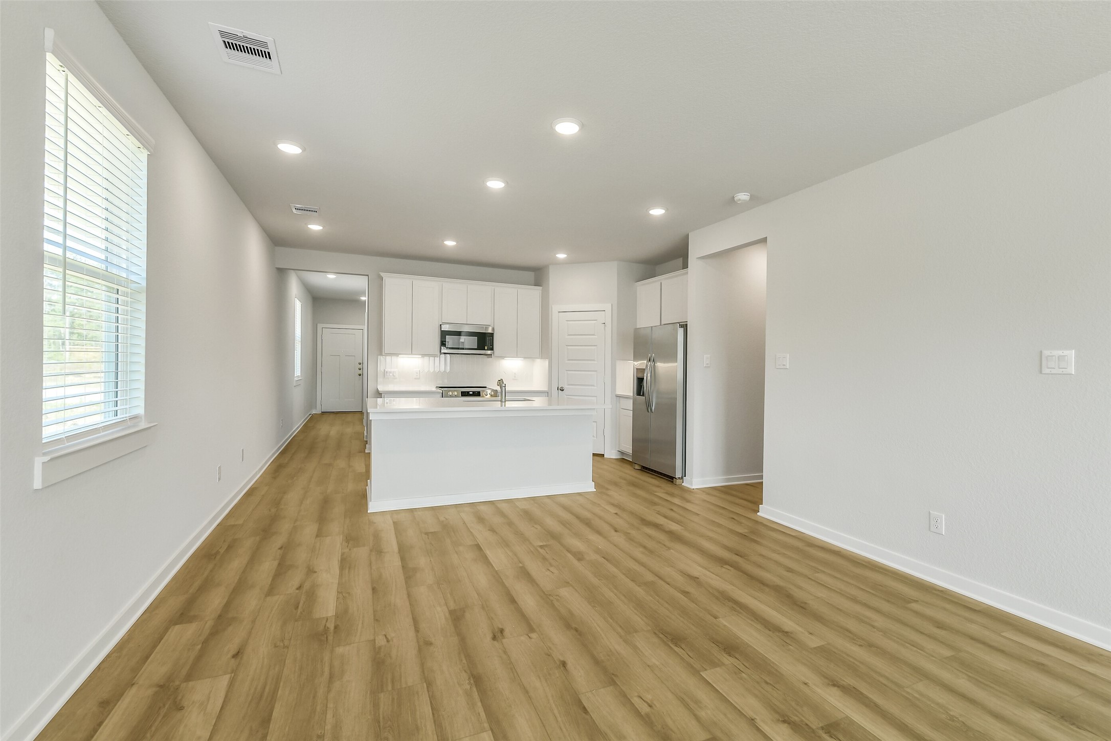 25980 Liberation Road Cleveland, TX 77328 - Photo 10 of 42 a view of kitchen with wooden floor and electronic appliances