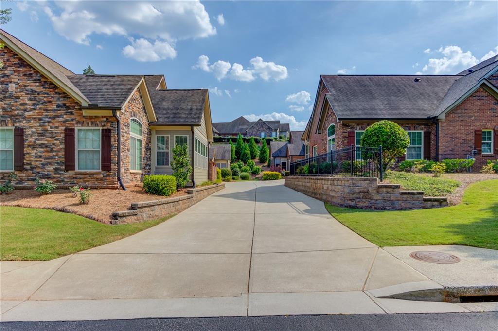 4165 Lanier Ridge Walk Cumming, GA 30041 - Photo 1 of 1 a front view of house with yard and green space