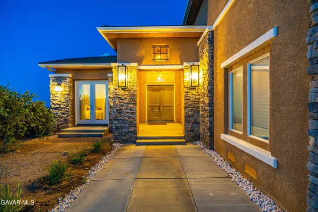 a dining room with furniture a chandelier and wooden floor