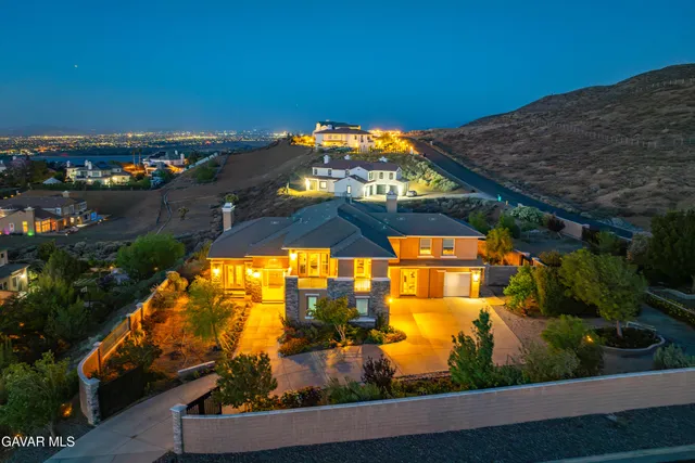 a living room with furniture fireplace and a large window