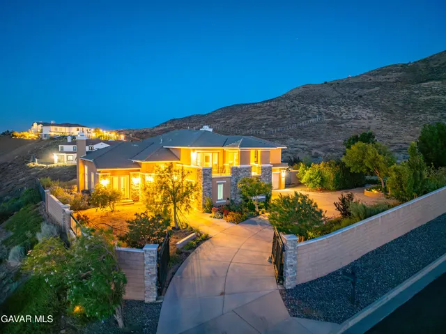 a living room with furniture a fireplace and a floor to ceiling window