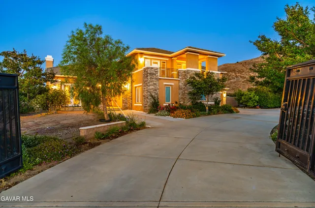 a living room with furniture fireplace and potted plants