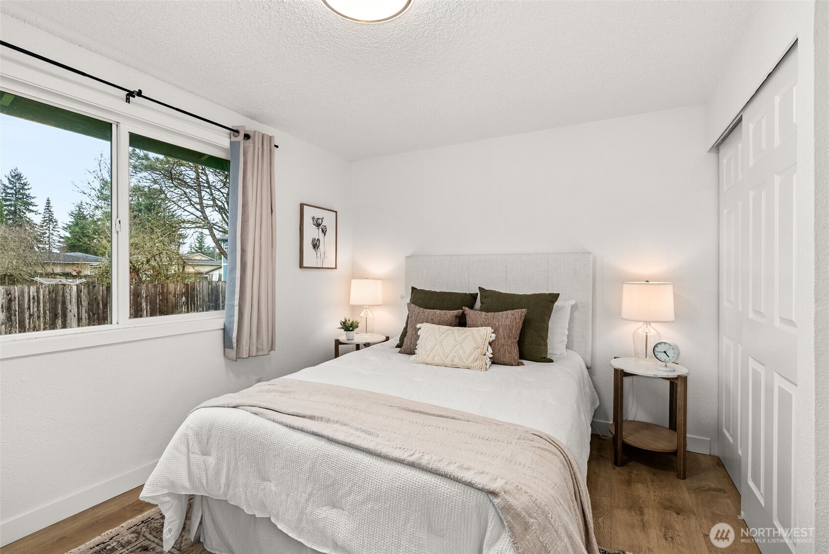 18821 Guava Street Southwest Rochester, WA 98579 - Photo 11 of 28 a bedroom with a large bed and a window