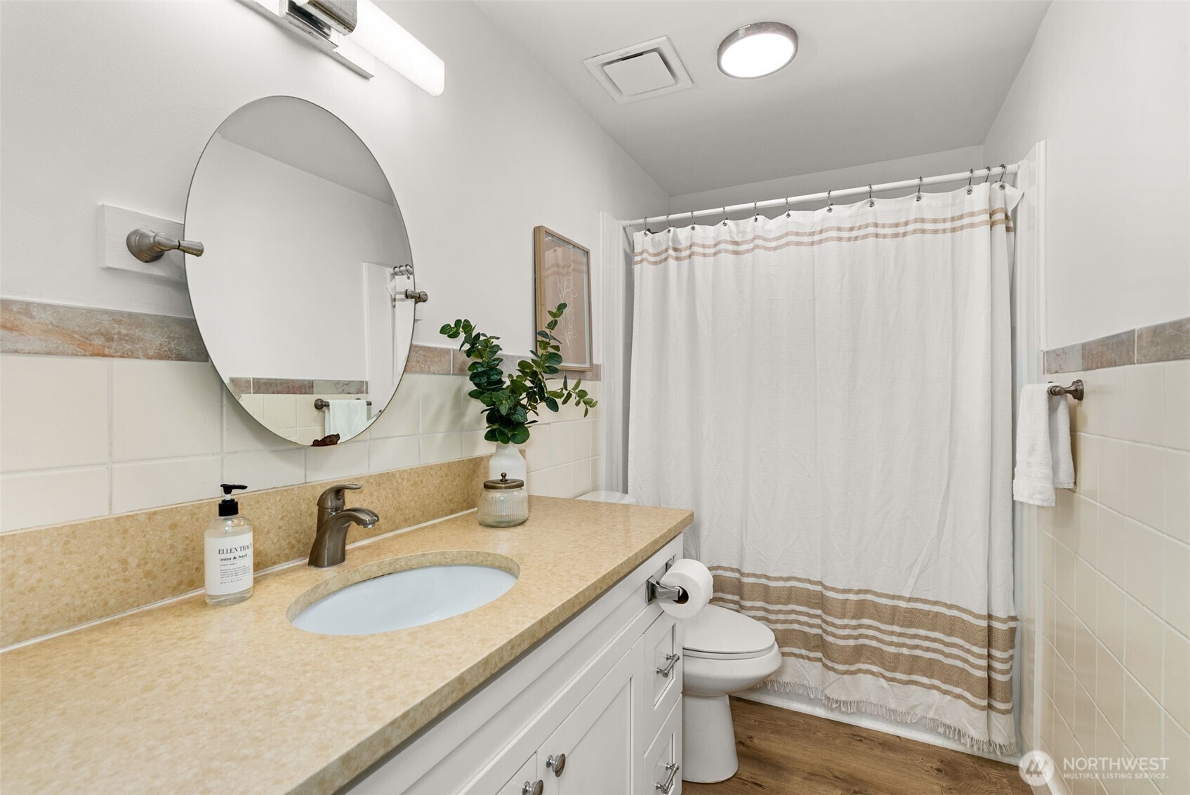 18821 Guava Street Southwest Rochester, WA 98579 - Photo 13 of 28 a bathroom with a granite countertop sink mirror vanity and toilet