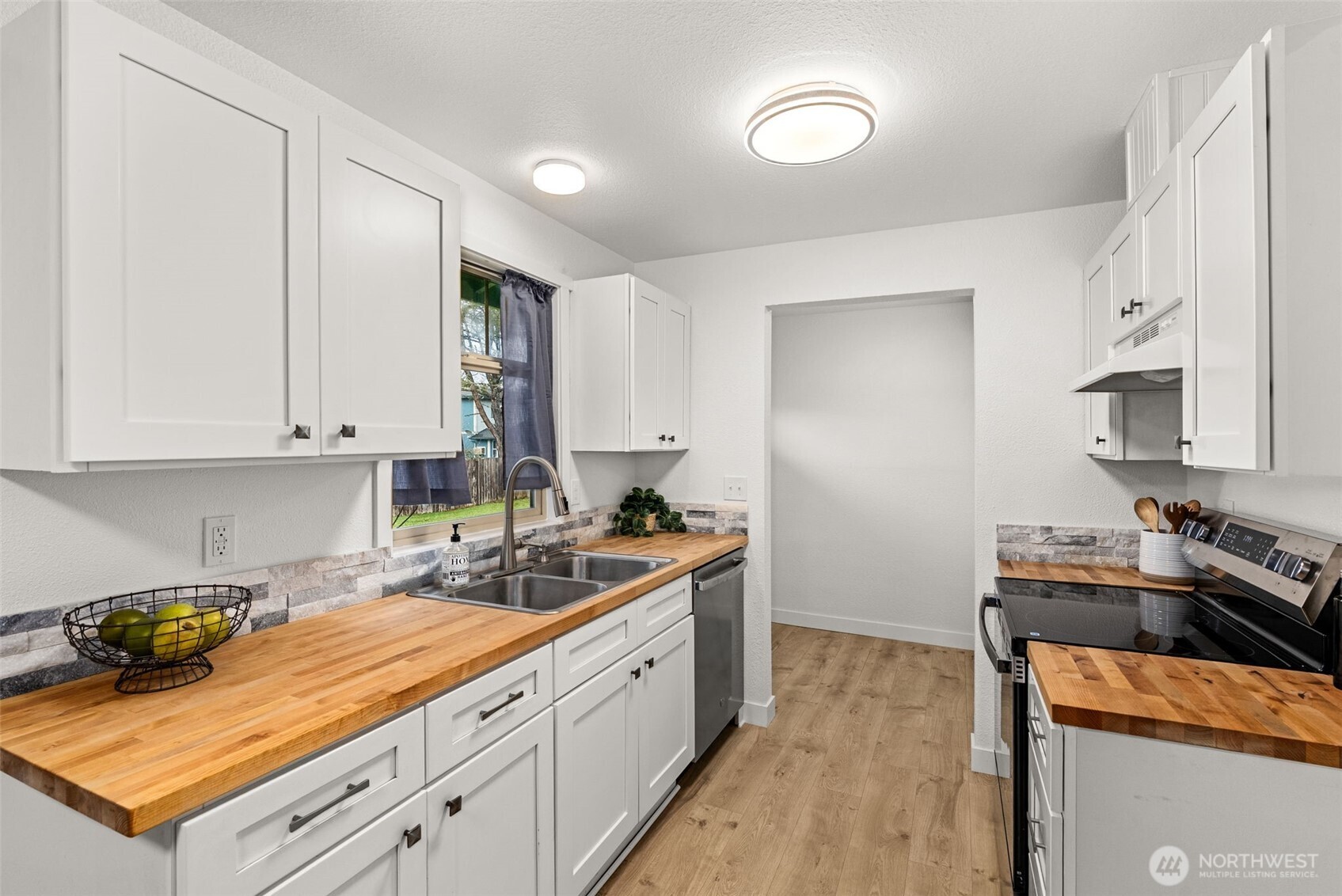 18821 Guava Street Southwest Rochester, WA 98579 - Photo 6 of 28 a kitchen with stainless steel appliances granite countertop a stove a sink and a refrigerator
