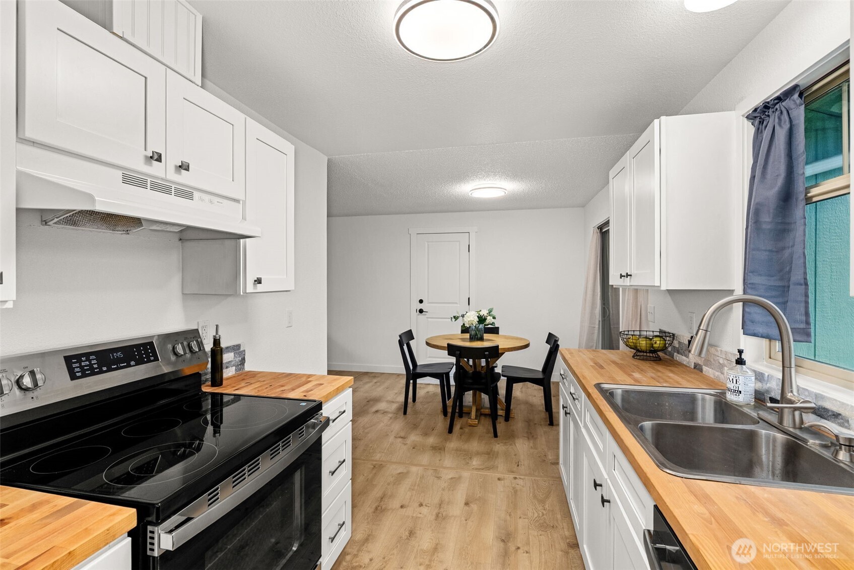 18821 Guava Street Southwest Rochester, WA 98579 - Photo 8 of 28 a kitchen with a stove and a sink