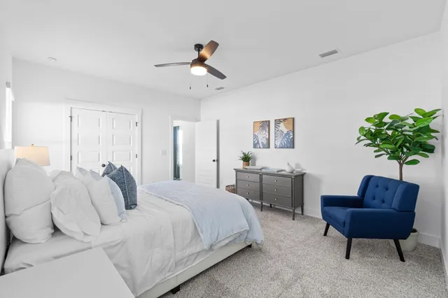 a spacious bedroom with a bed and a couch