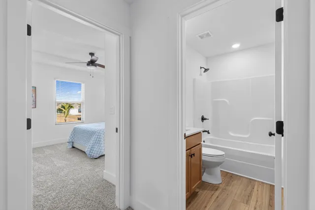 a bathroom with a granite countertop toilet a sink and bathtub