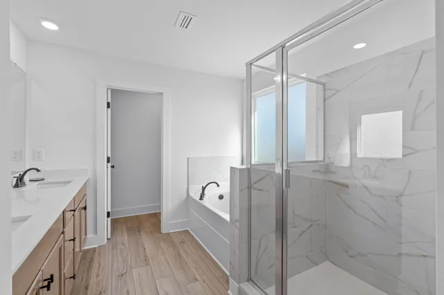 a bathroom with a double vanity sink a mirror and a shower