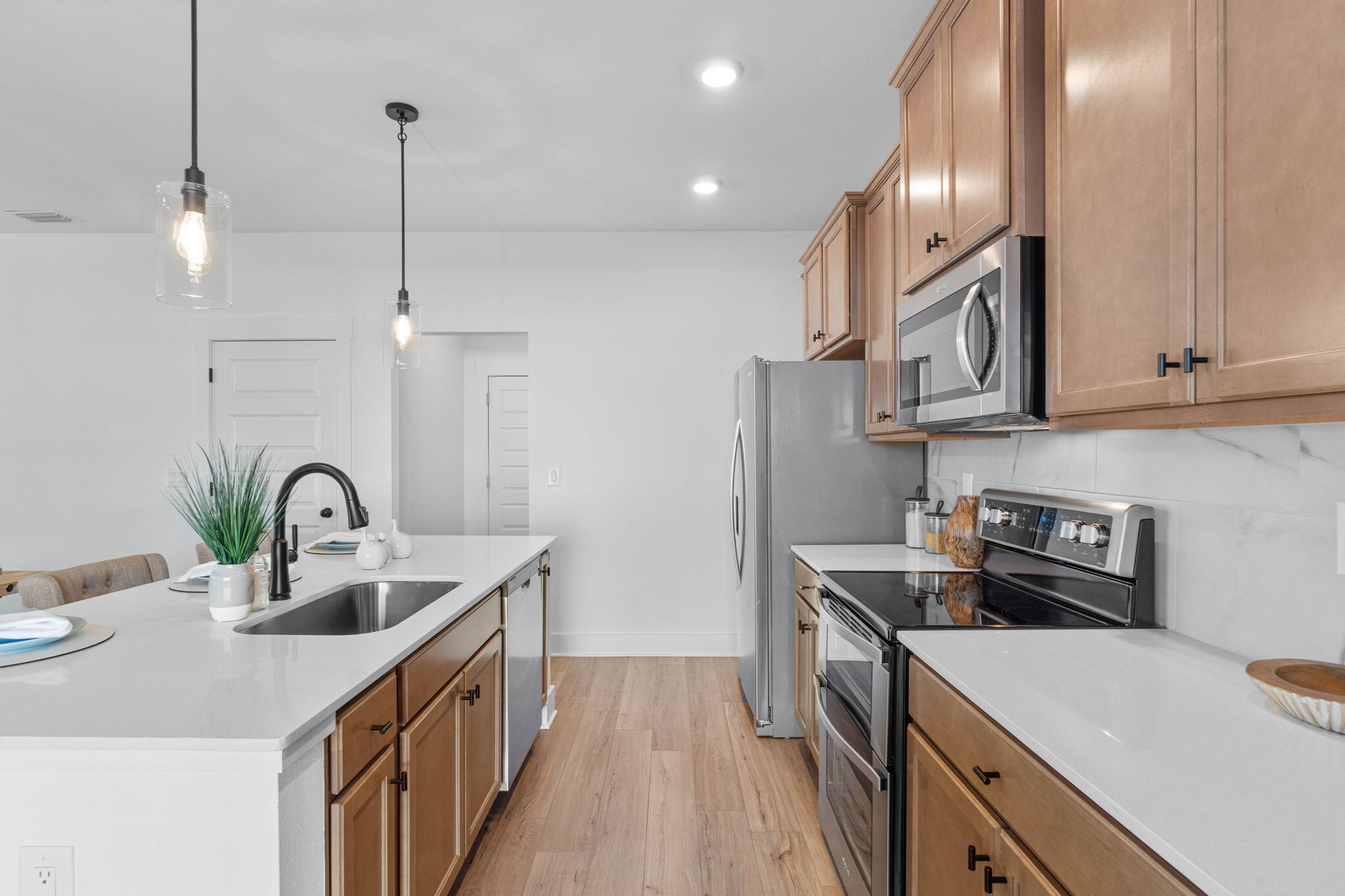 41 Sweetclover Street Freeport, FL 32439 - Photo 9 of 35 a kitchen with kitchen island granite countertop a sink a counter space appliances and cabinets