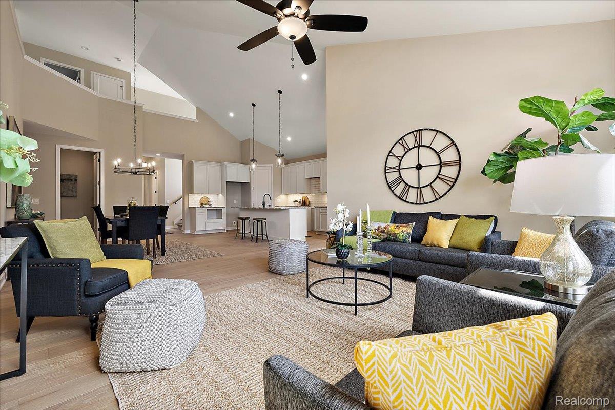 2032 Breckenridge Court, Unit 9 Rochester, MI 48309 - Photo 13 of 39 Living room featuring light wood finished floors, high vaulted ceiling, a ceiling fan, recessed lighting, and a chandelier