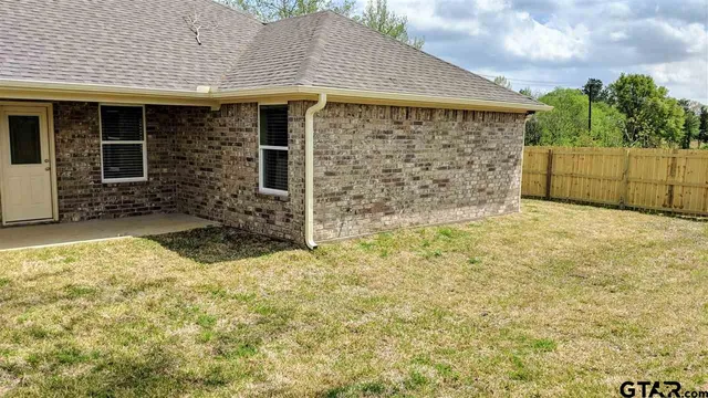 a view of a backyard of the house