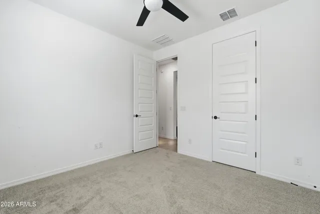 a kitchen with a stove a sink a refrigerator and chairs