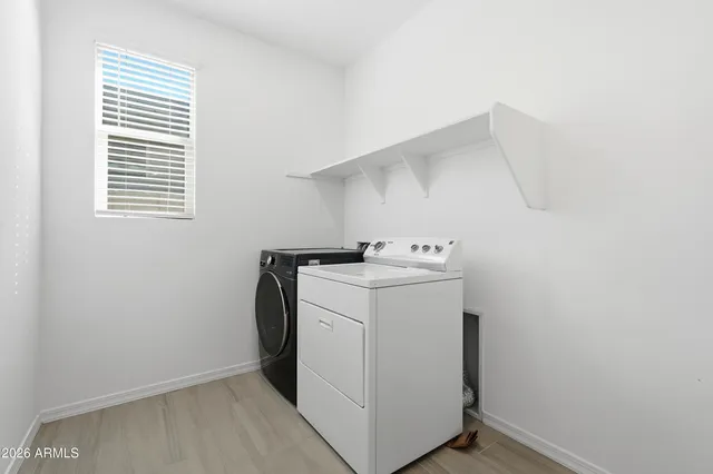 a large bathroom with a tub sink and mirror