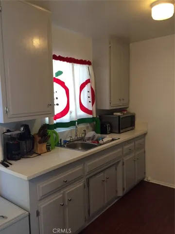 a kitchen with stainless steel appliances white cabinets and a sink