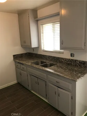 a view of a room with wooden floor and windows