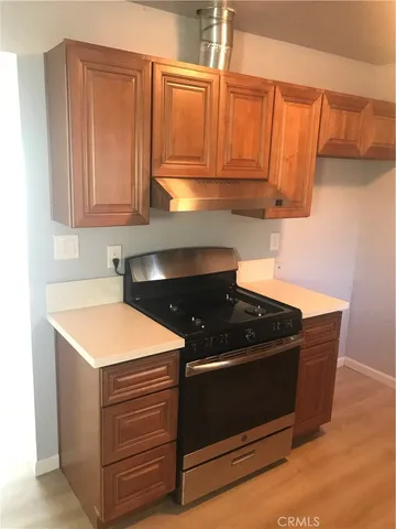 a kitchen with stainless steel appliances granite countertop a stove a microwave and a sink