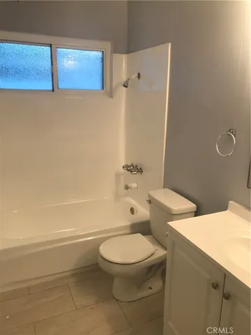 a bathroom with a toilet a sink and shower