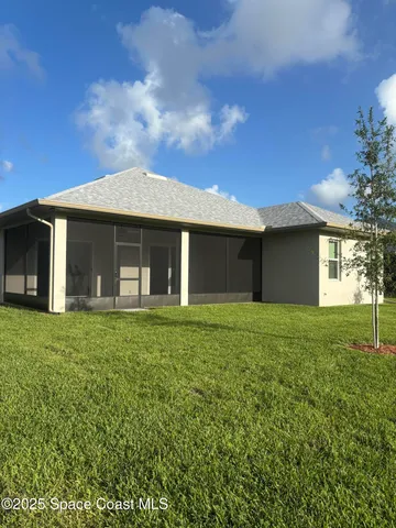 a front view of a house with a garden and yard