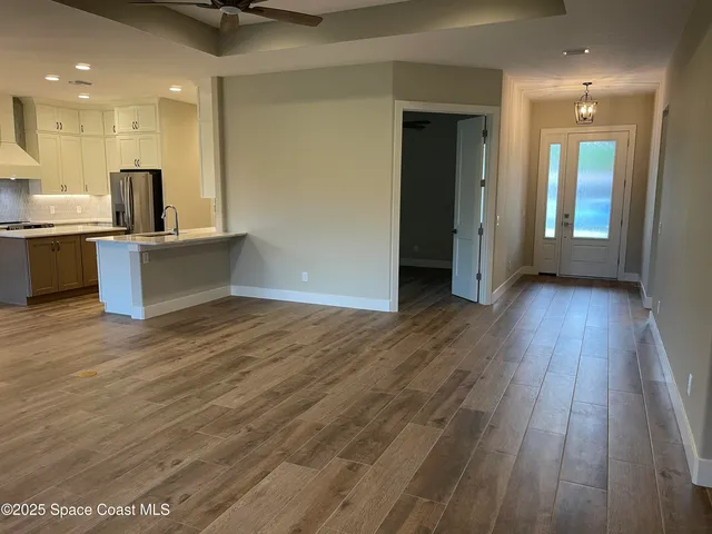 a view of kitchen with wooden floor and electronic appliances