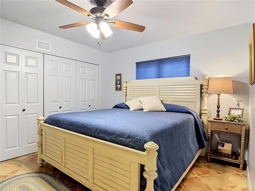 1395 Maytown Road Osteen, FL 32764 - Photo 35 of 65 a bedroom with a bed and a chandelier