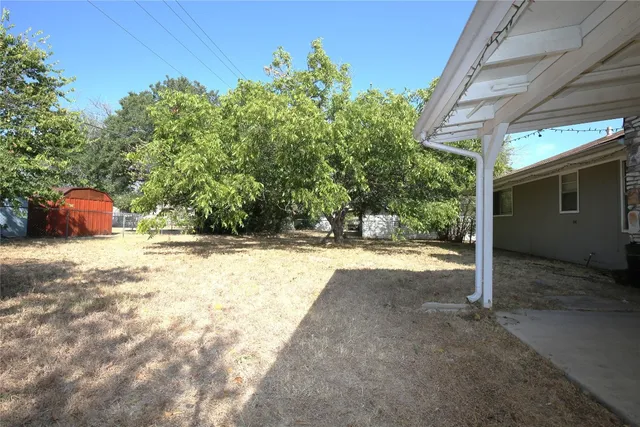 a view of a backyard of the house