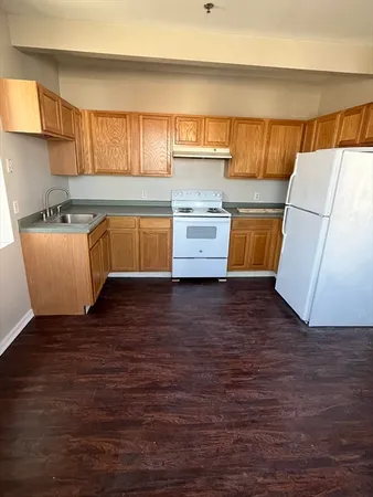 a kitchen with wooden cabinets and a sink