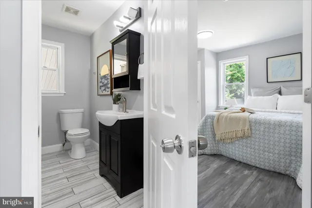 a bathroom with a sink toilet and mirror