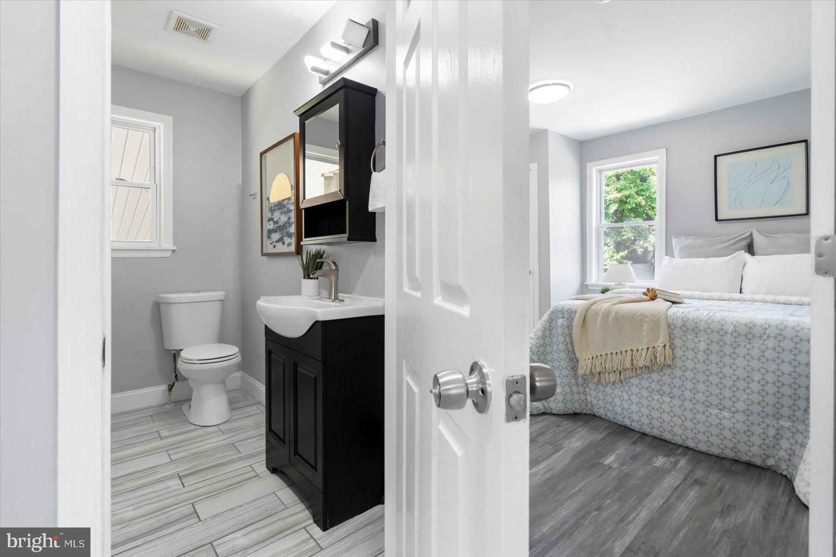 6628 Hartwait Street Baltimore, MD 21224 - Photo 12 of 31 a bathroom with a sink toilet and mirror