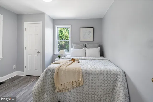 a bedroom with a bed and a painting on the wall