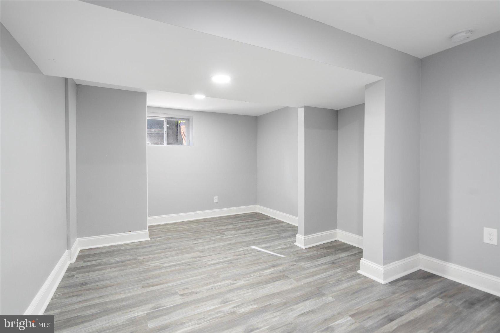 6628 Hartwait Street Baltimore, MD 21224 - Photo 20 of 31 a view of an empty room with wooden floor
