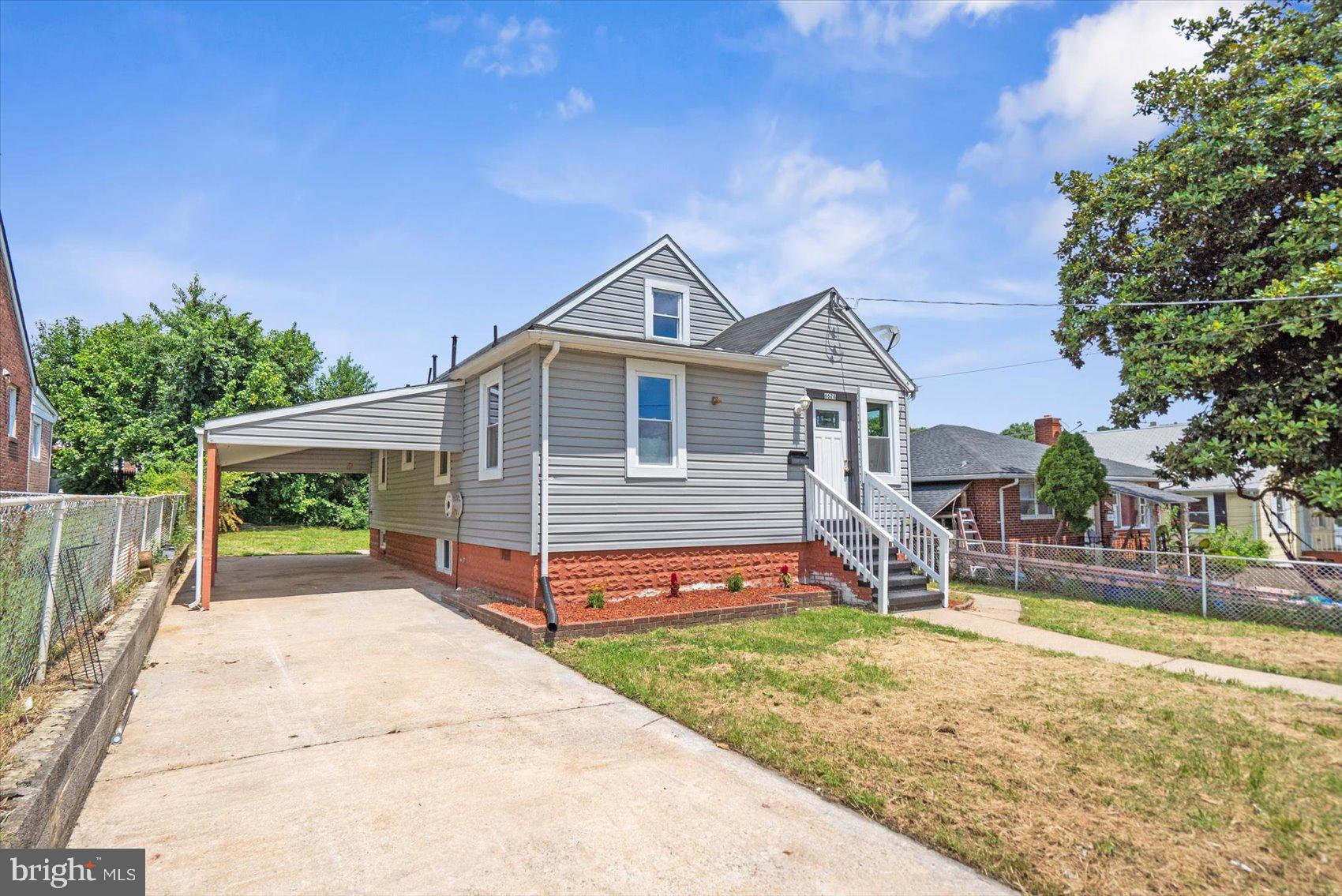 6628 Hartwait Street Baltimore, MD 21224 - Photo 2 of 31 a front view of a house with a yard and table and chairs