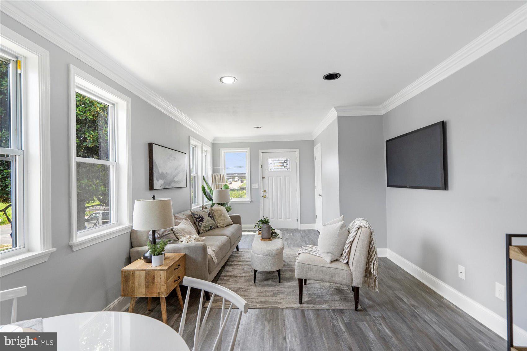 6628 Hartwait Street Baltimore, MD 21224 - Photo 4 of 31 a living room with furniture and a flat screen tv