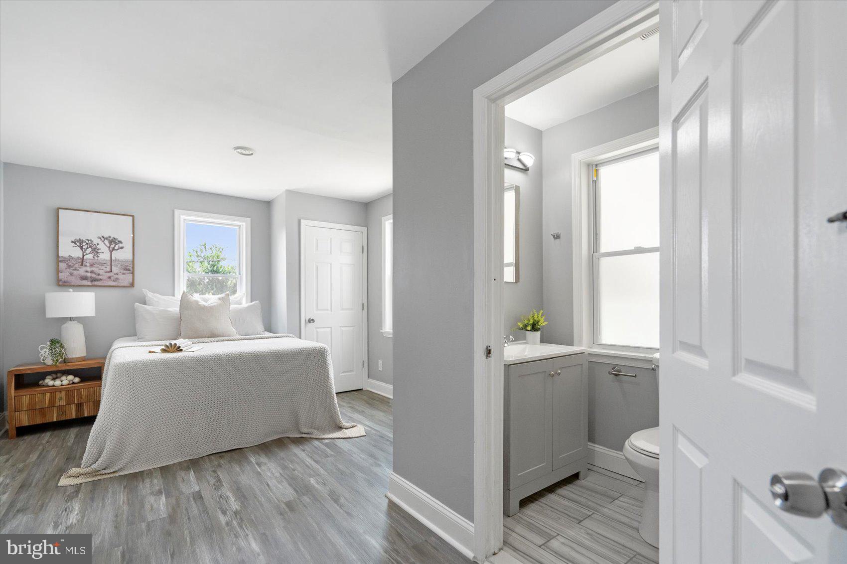 6628 Hartwait Street Baltimore, MD 21224 - Photo 9 of 31 a living room with furniture and a window with wooden floor