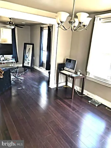 a view of a livingroom with furniture wooden floor and windows