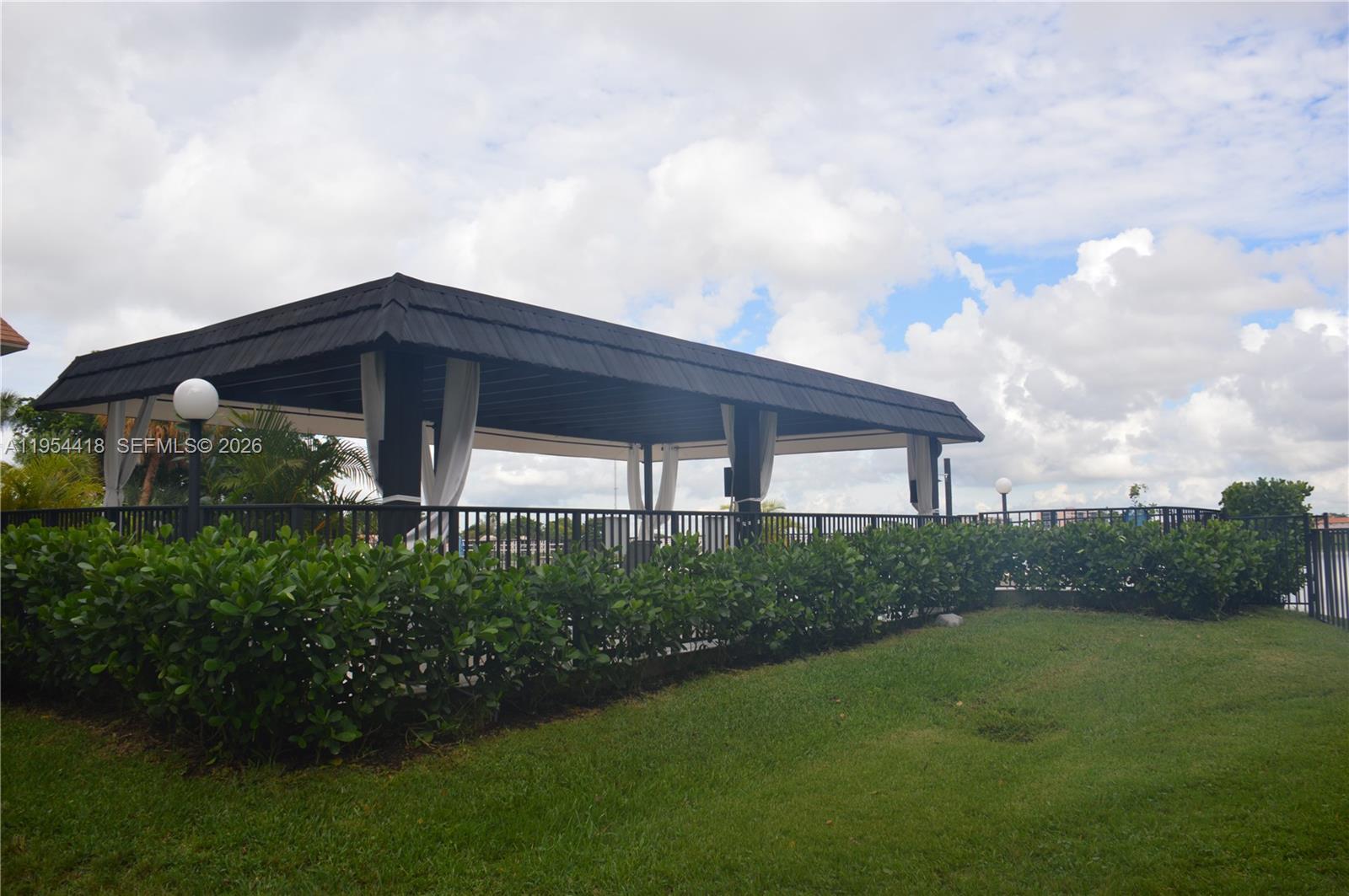 461 Ives Dairy Road, Unit 4042 Miami, FL 33179 - Photo 14 of 20 a front view of a house with garden