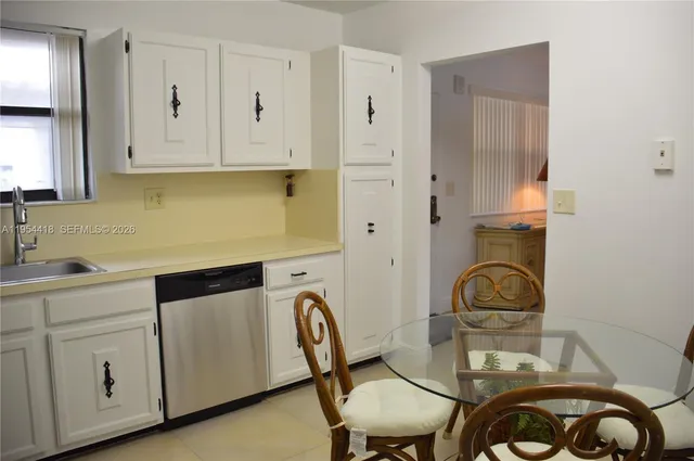 a kitchen with sink cabinets and stove
