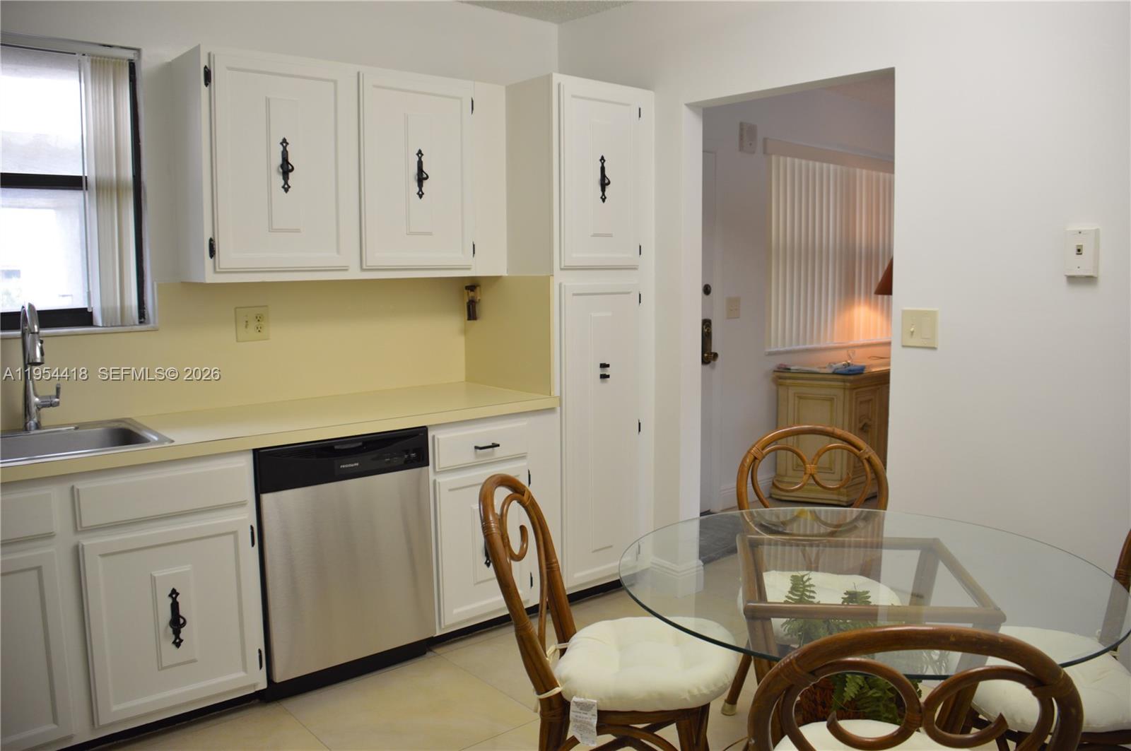 461 Ives Dairy Road, Unit 4042 Miami, FL 33179 - Photo 6 of 20 a kitchen with sink cabinets and stove